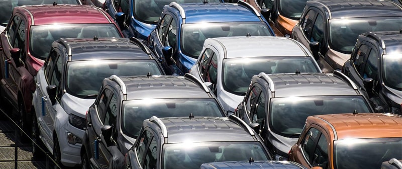 Multiple cars parked in an open area