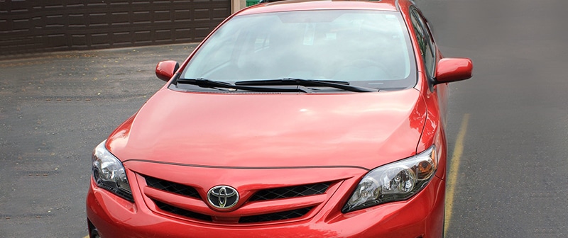 Red Toyota Corolla sedan from the VPI Cars rental fleet